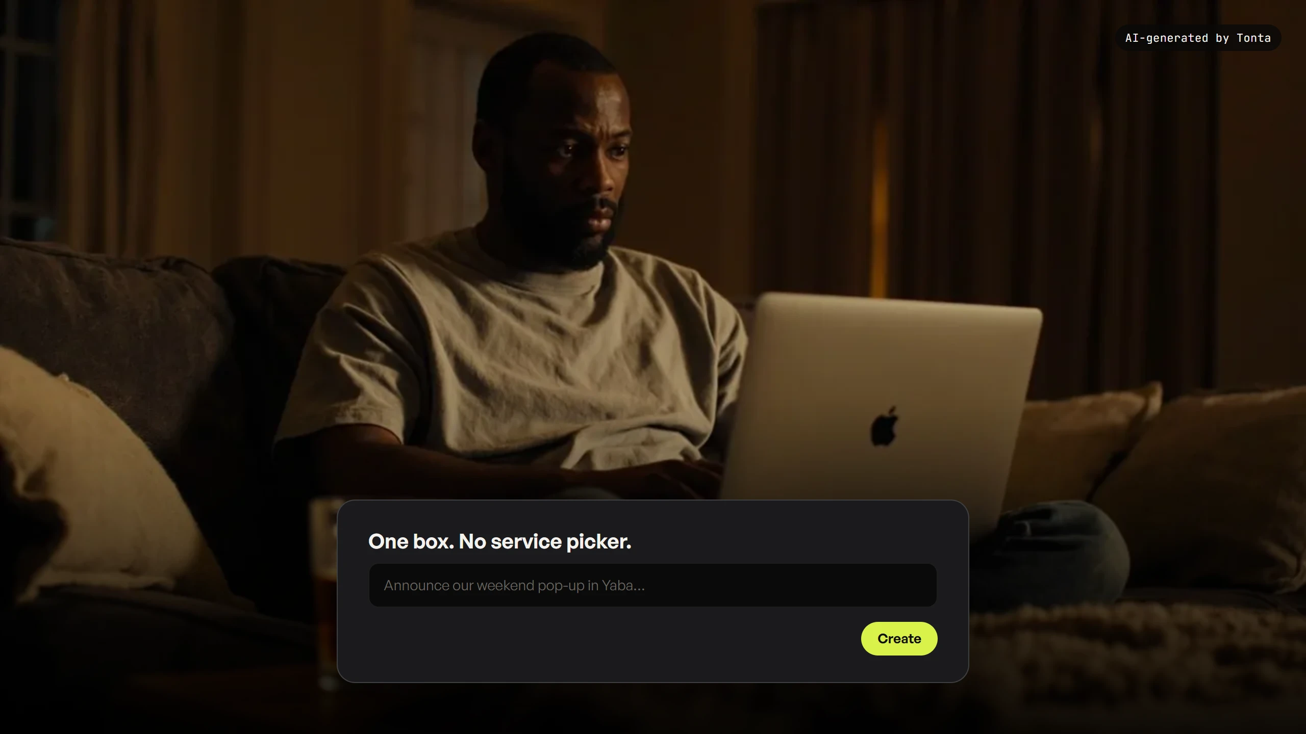 A fictional creator typing one thing into a single box on a laptop at home, relaxed on a sofa.